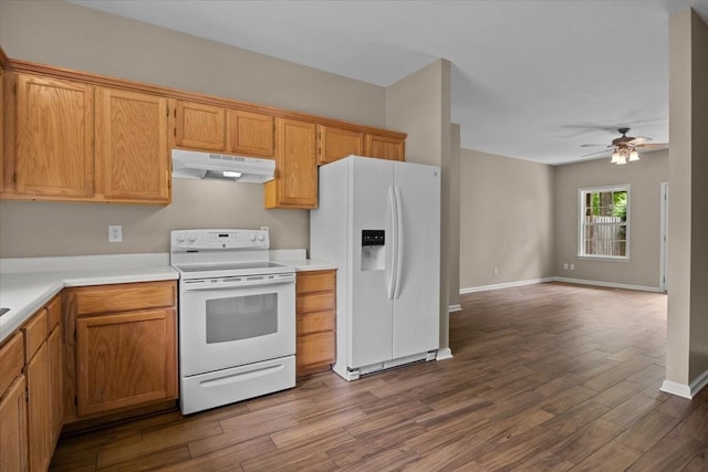 7203 Rosemary Ct, Fairview, TN 37062 - kitchen with white appliances, light countertops, a ceiling fan, under cabinet range hood, and dark wood-style floors