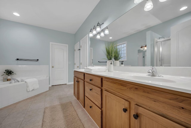 full bathroom featuring tile patterned flooring, double vanity, a bath, a sink, and a stall shower