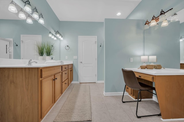 full bathroom featuring tile patterned flooring, a sink, baseboards, and double vanity