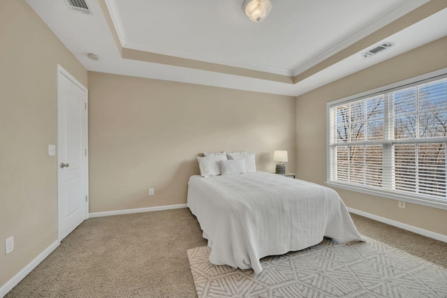 bedroom with visible vents, carpet flooring, baseboards, and a tray ceiling