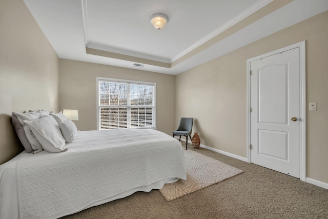 carpeted bedroom featuring crown molding, a raised ceiling, baseboards, and visible vents