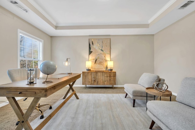 office area with crown molding, baseboards, visible vents, and a raised ceiling