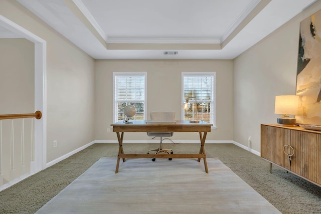 carpeted office space with visible vents, ornamental molding, a raised ceiling, and baseboards