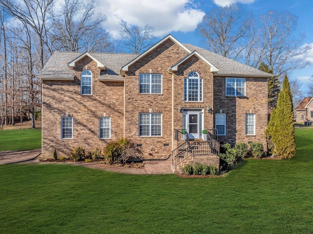 view of front of property with brick siding and a front yard