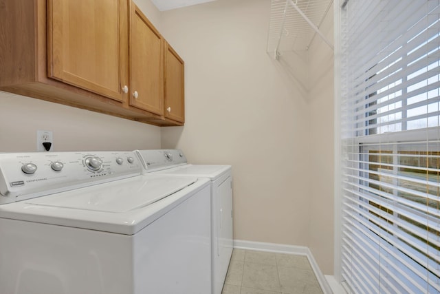 laundry area featuring baseboards, cabinet space, independent washer and dryer, and light tile patterned flooring