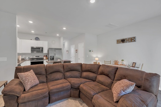 living room featuring recessed lighting, visible vents, and light wood finished floors