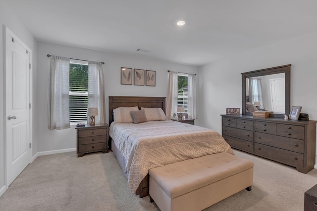 bedroom with baseboards, recessed lighting, visible vents, and light carpet