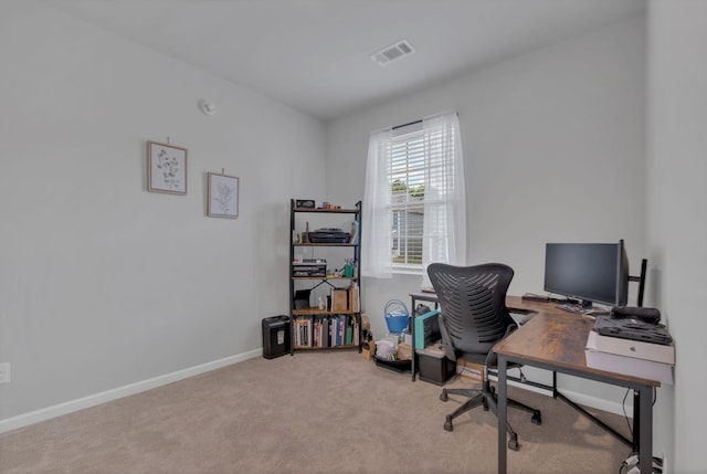 carpeted office space with baseboards and visible vents