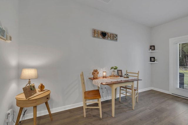 dining room with baseboards and wood finished floors