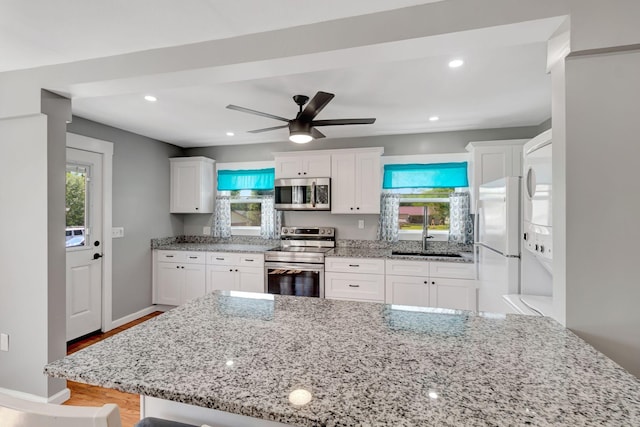 307 Franklin St, Cowan, TN 37318 - kitchen featuring appliances with stainless steel finishes, a sink, plenty of natural light, white cabinets, and recessed lighting