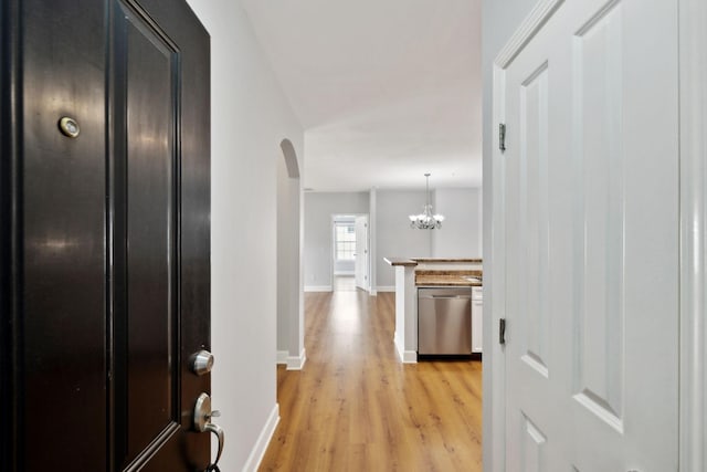 8231 Lenox Creekside Dr Unit C7, Antioch, TN 37013 - hallway with arched walkways, light wood-type flooring, baseboards, and a chandelier