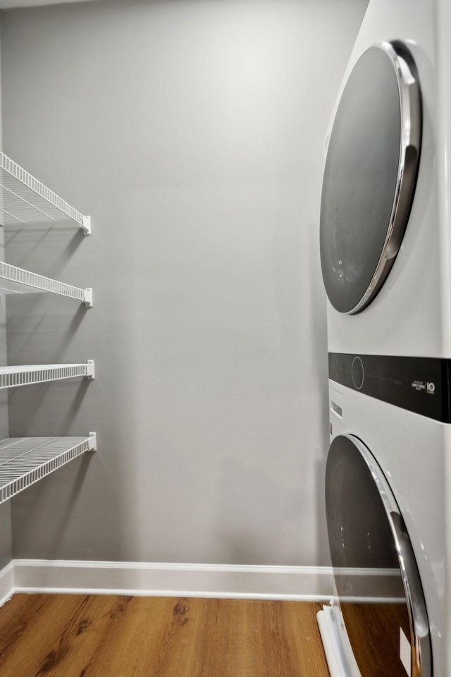8231 Lenox Creekside Dr Unit C7, Antioch, TN 37013 - washroom featuring stacked washer / drying machine, baseboards, and wood finished floors