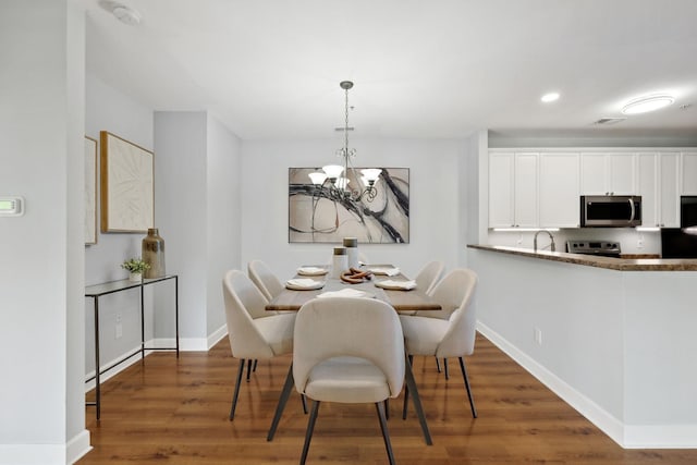 8231 Lenox Creekside Dr Unit C7, Antioch, TN 37013 - dining room with a chandelier, wood finished floors, baseboards, and recessed lighting