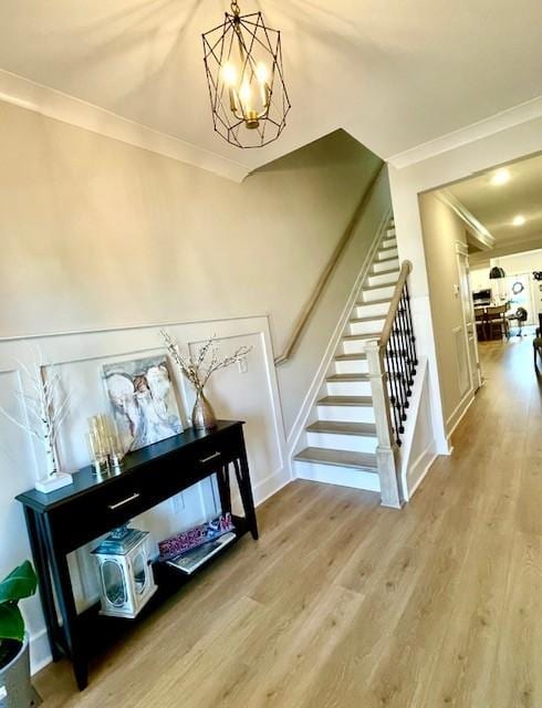 113 Cryer Dr, Gallatin, TN 37066 - stairway featuring a notable chandelier, ornamental molding, and wood finished floors