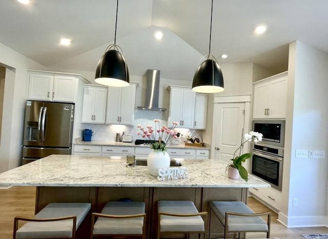 113 Cryer Dr, Gallatin, TN 37066 - kitchen featuring light wood-type flooring, wall chimney exhaust hood, white cabinetry, and stainless steel appliances