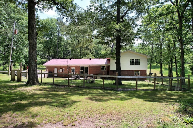 286 Pine Grove Rd, South Pittsburg, TN 37380 - rear view of house with a lawn, fence, and brick siding