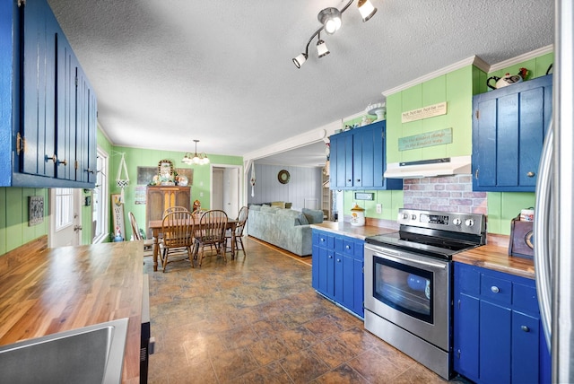 kitchen with a textured ceiling, butcher block counters, under cabinet range hood, and stainless steel electric stove