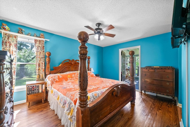 bedroom featuring baseboards, a ceiling fan, a textured ceiling, and wood finished floors
