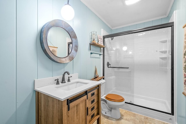 full bathroom with vanity, ornamental molding, toilet, and a shower stall