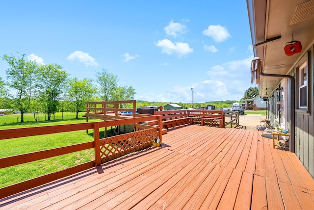 wooden deck featuring a lawn