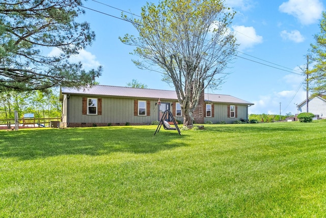 view of front facade featuring a front lawn and metal roof