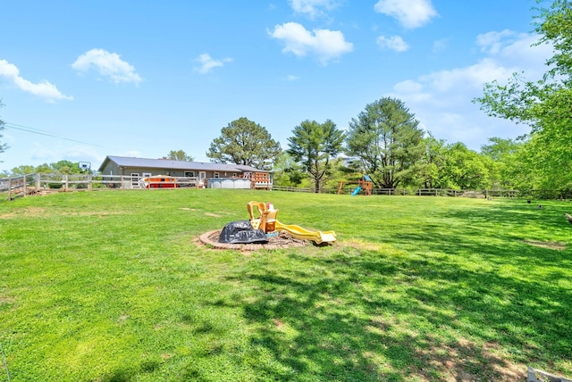 view of yard featuring a playground and a fenced backyard