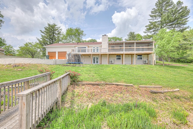 411 Willow Lake Dr, Portland, TN 37148 - back of house with a trampoline, a chimney, a yard, and a deck