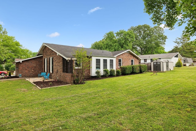 1031 Bayview Dr, Gallatin, TN 37066 - rear view of property with a storage unit, a lawn, an outbuilding, and brick siding