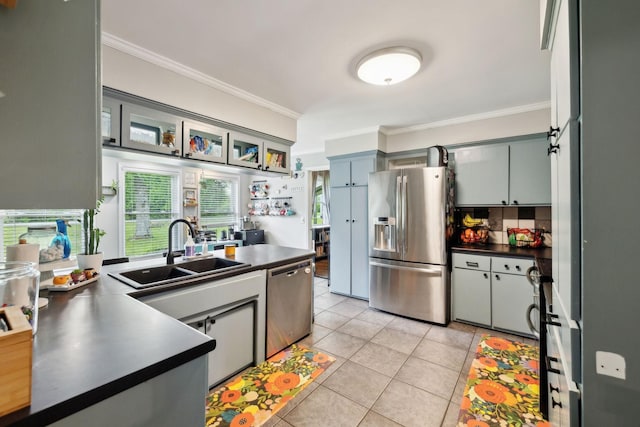 1031 Bayview Dr, Gallatin, TN 37066 - kitchen with ornamental molding, dark countertops, a sink, appliances with stainless steel finishes, and light tile patterned floors