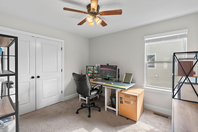 office with a ceiling fan, baseboards, visible vents, and carpet