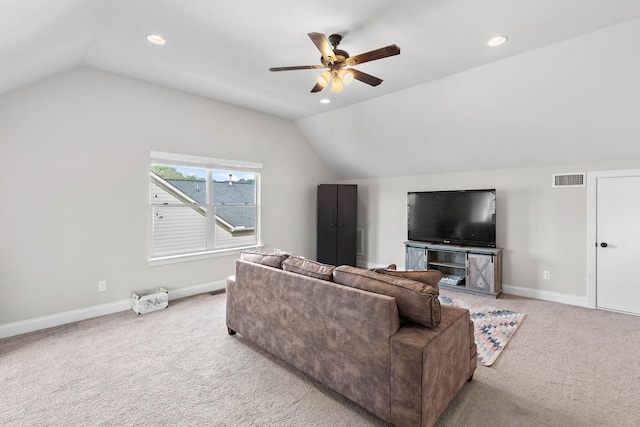 living area with visible vents, a ceiling fan, vaulted ceiling, and light colored carpet