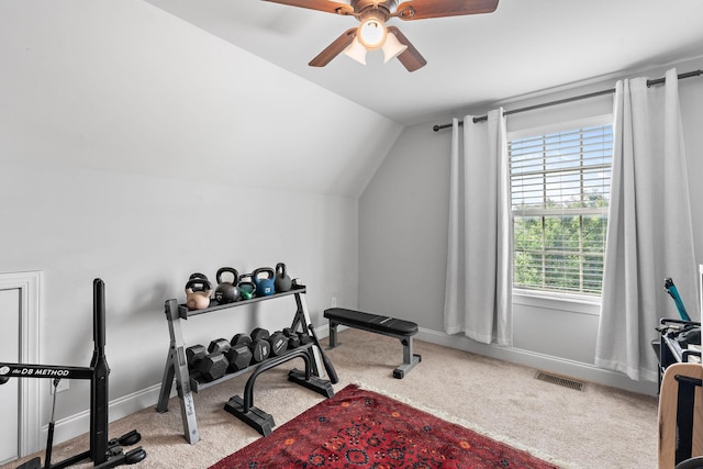 exercise room featuring visible vents, baseboards, ceiling fan, carpet flooring, and vaulted ceiling