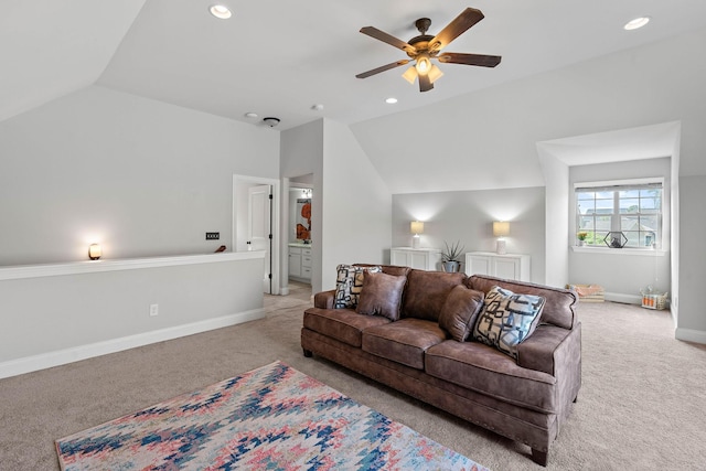 living room featuring a ceiling fan, baseboards, lofted ceiling, and carpet