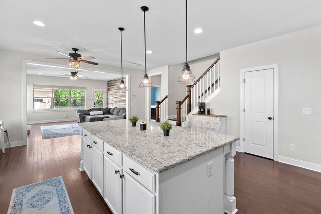 kitchen with baseboards, white cabinetry, ceiling fan, and dark wood finished floors