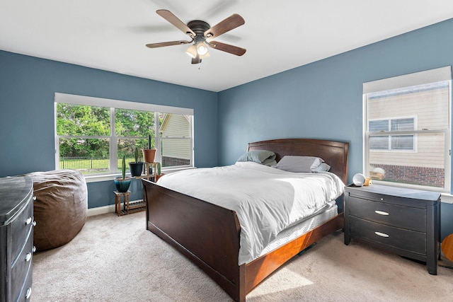 bedroom featuring baseboards, ceiling fan, and light colored carpet