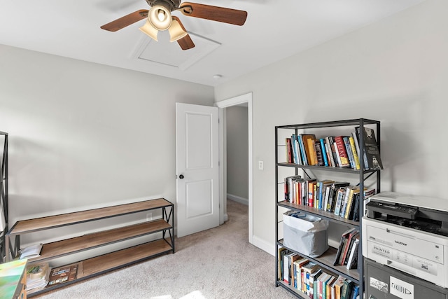 interior space with baseboards, ceiling fan, and carpet flooring