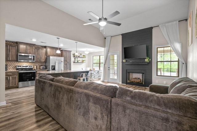 757 Tidwell Dr, Clarksville, TN 37042 - living area with a fireplace, a ceiling fan, wood finished floors, lofted ceiling, and visible vents