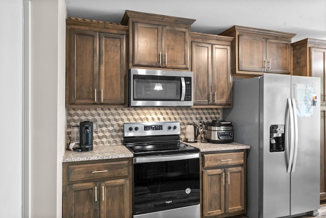 757 Tidwell Dr, Clarksville, TN 37042 - kitchen with light stone counters, appliances with stainless steel finishes, and tasteful backsplash