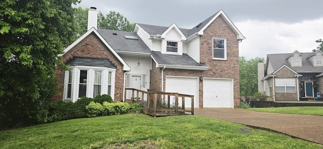 traditional-style house featuring a garage, driveway, a front lawn, and brick siding