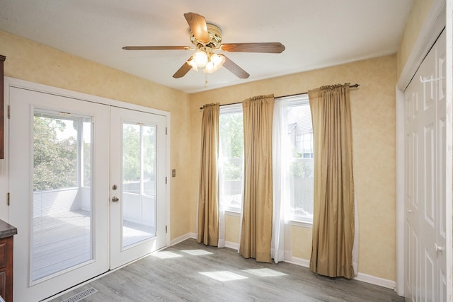 entryway with french doors, wood finished floors, ceiling fan, and baseboards