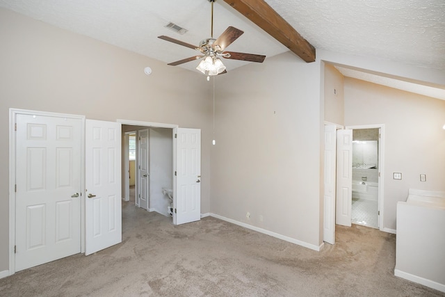 unfurnished bedroom featuring carpet, beam ceiling, baseboards, high vaulted ceiling, and a textured ceiling