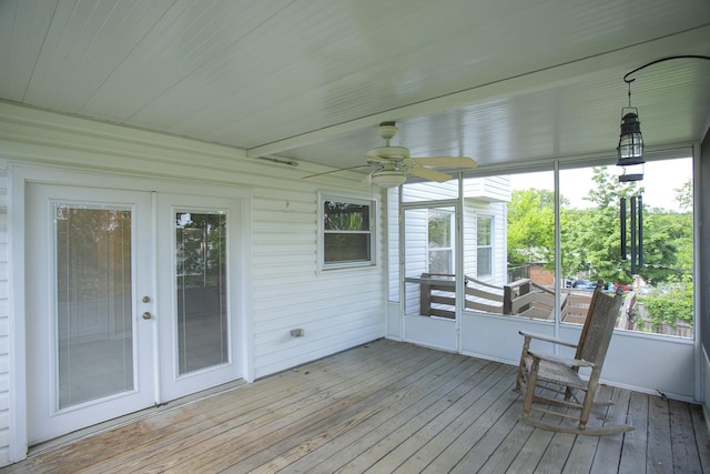 sunroom / solarium featuring a ceiling fan, french doors, and plenty of natural light