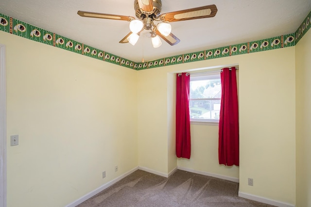 unfurnished room featuring carpet flooring, a ceiling fan, and baseboards