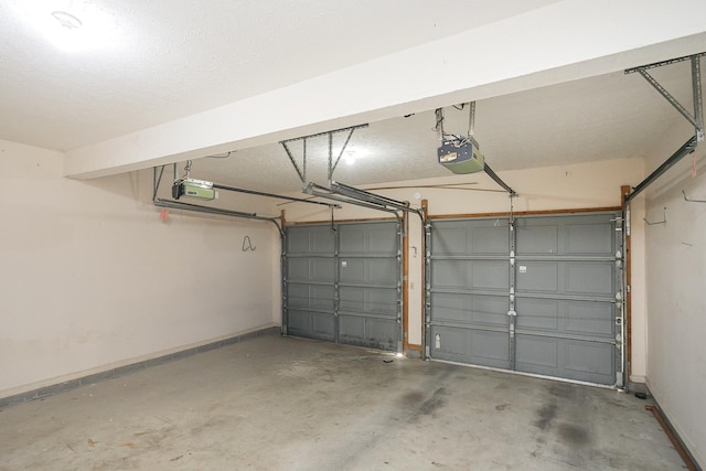 garage featuring a garage door opener and baseboards