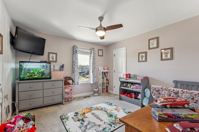 carpeted bedroom with baseboards, a ceiling fan, and visible vents