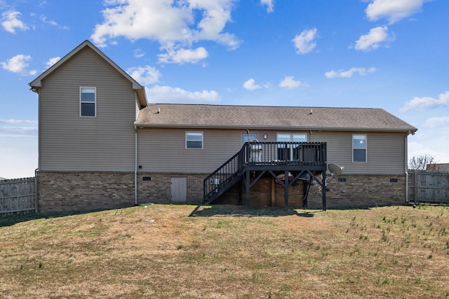 rear view of house with fence, stairs, brick siding, a deck, and a yard
