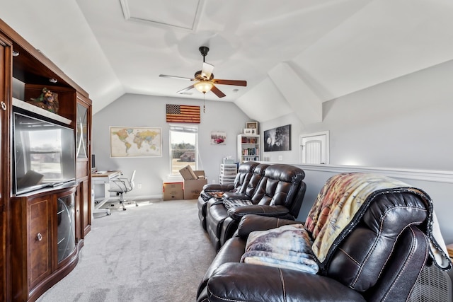 carpeted living room with ceiling fan and vaulted ceiling