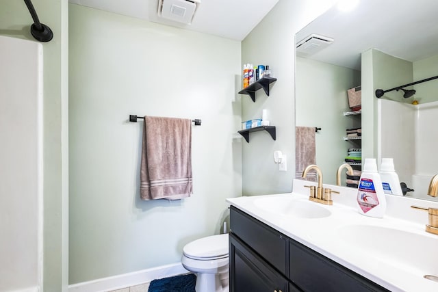 bathroom featuring double vanity, toilet, a sink, and a shower