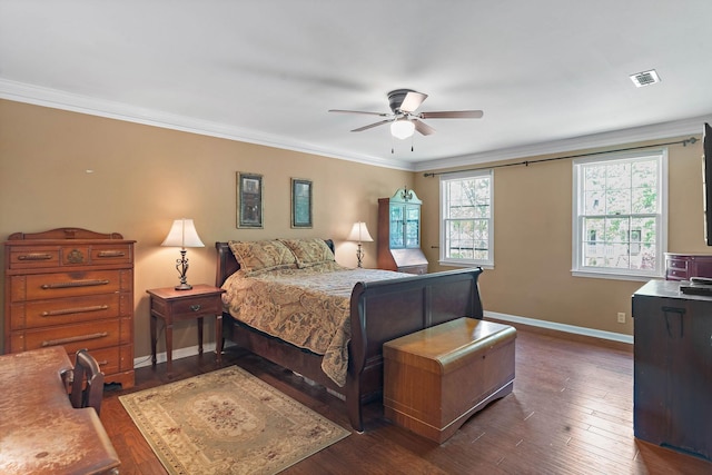 bedroom featuring dark wood-style flooring, baseboards, visible vents, and ornamental molding