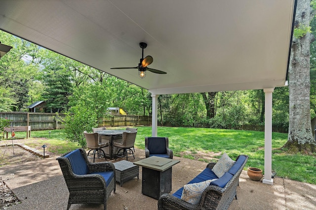 view of patio featuring outdoor dining area, a fenced backyard, and a ceiling fan